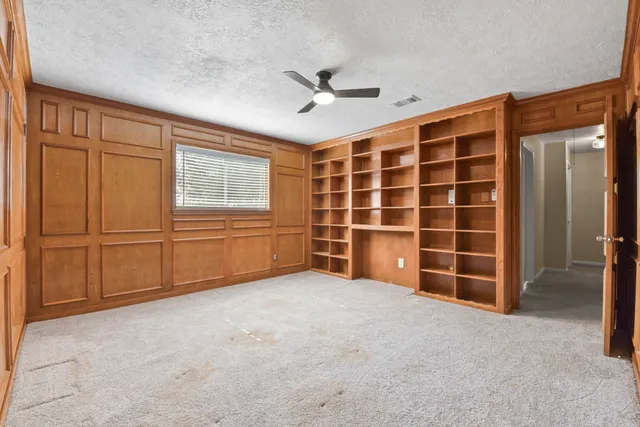 a view of an empty room with a cabinet