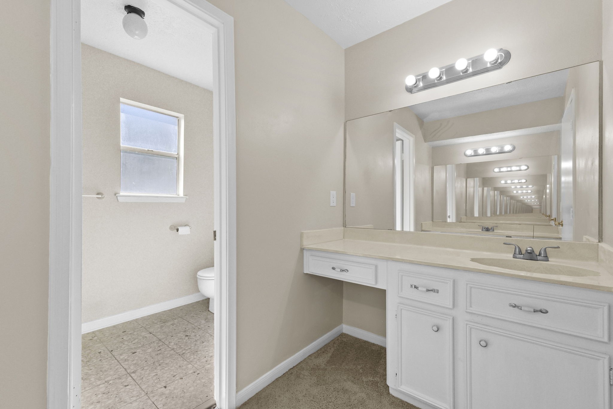 6507 Spring Leaf Drive Spring, TX 77379 - Photo 30 of 34 a bathroom with a sink a toilet and a mirror