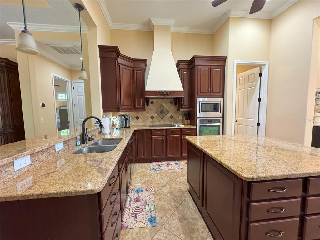 1024 West Beagle Run Loop Hernando, FL 34442 - Photo 16 of 44 a kitchen with stainless steel appliances granite countertop a sink stove and refrigerator