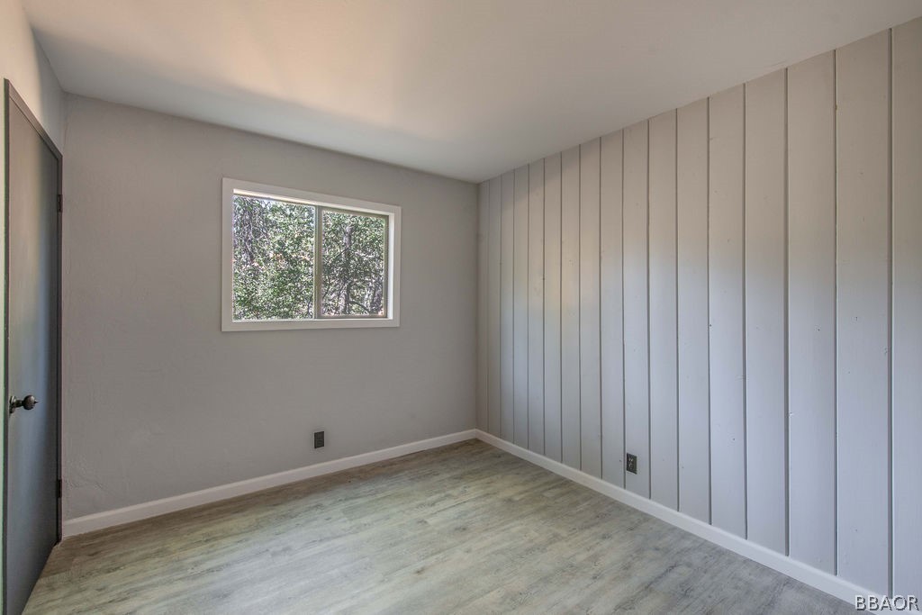 186 Riverside Avenue Sugarloaf, CA 92386 - Photo 23 of 34 a view of an empty room with wooden floor and a window
