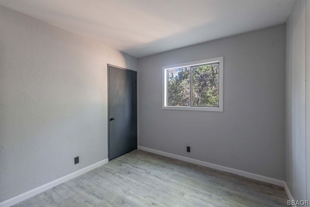 186 Riverside Avenue Sugarloaf, CA 92386 - Photo 24 of 34 a view of room with hardwood floor and window