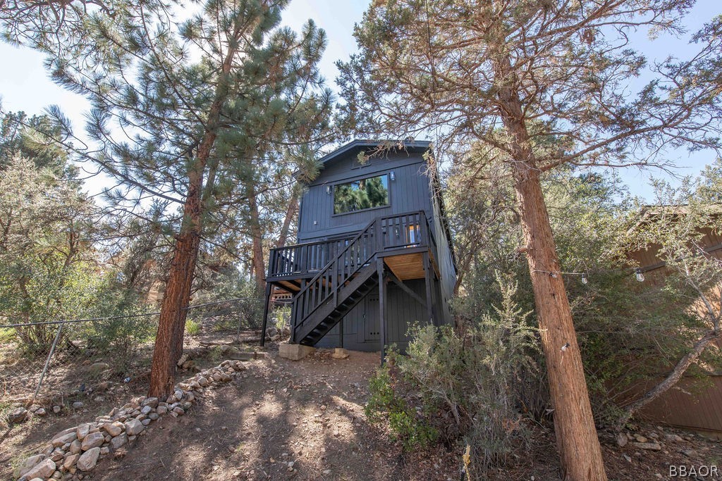 186 Riverside Avenue Sugarloaf, CA 92386 - Photo 3 of 34 a view of a wooden house with a tree