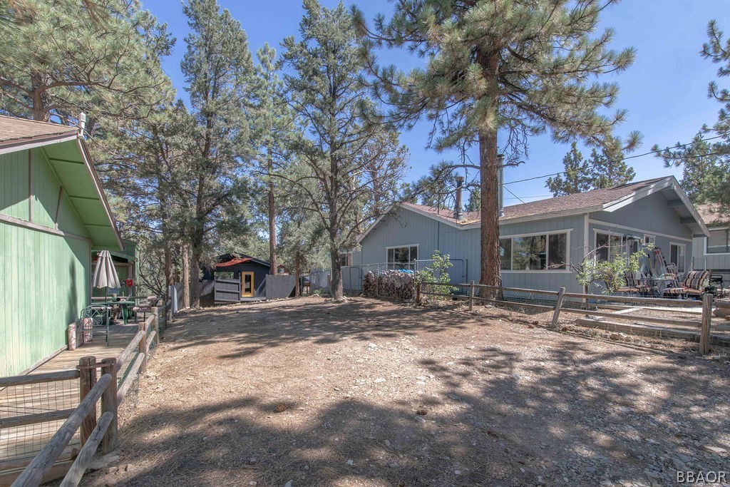 186 Riverside Avenue Sugarloaf, CA 92386 - Photo 31 of 34 a wooden house with trees in front of it