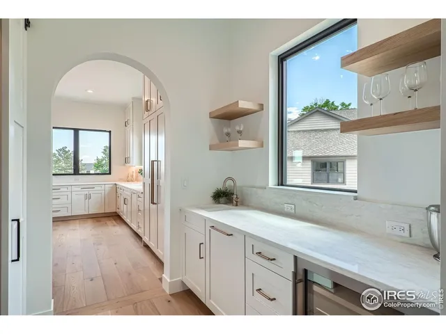 a en suite bathroom with a granite countertop sink mirror and bathtub