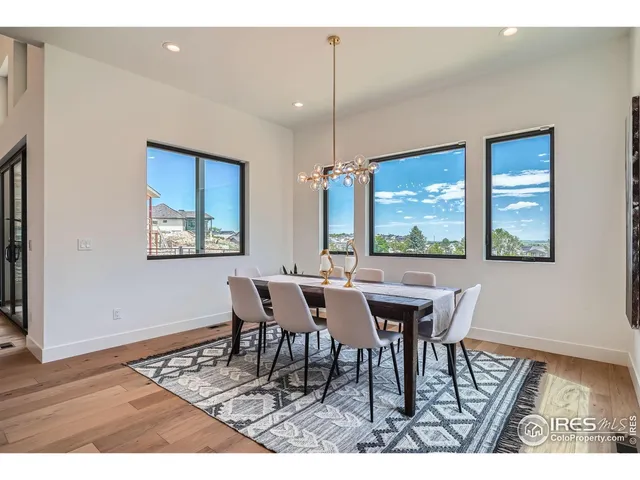 a dining room with furniture a chandelier and wooden floor