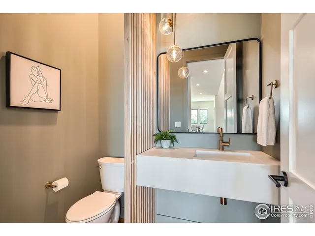 a bathroom with a sink mirror vanity and toilet