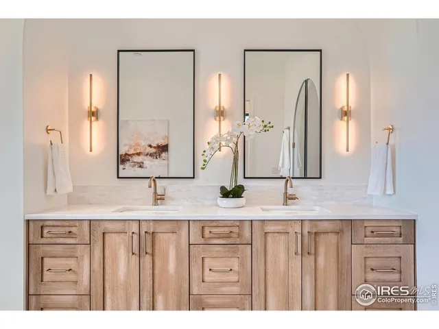 a bathroom with a double vanity sink and a mirror