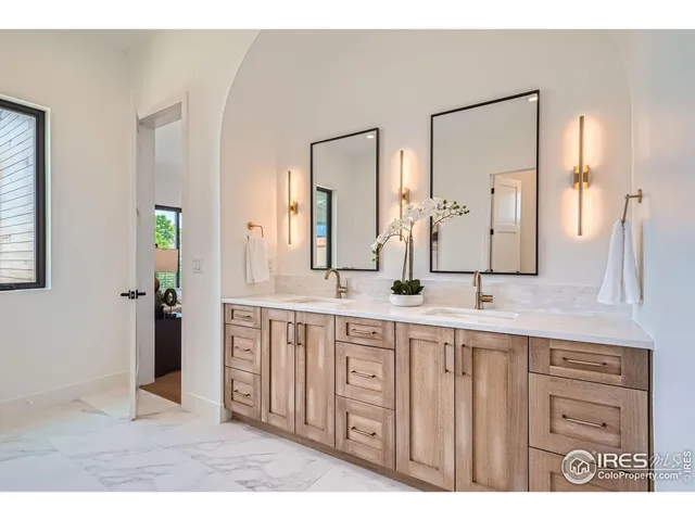 a spacious bathroom with a double vanity sink and a mirror