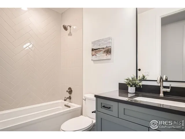 a bathroom with a sink a toilet and bathtub
