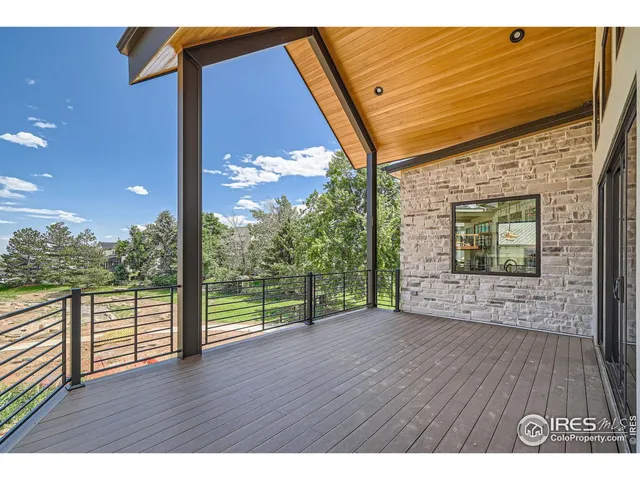 a view of a room with wooden floor and a floor to ceiling window