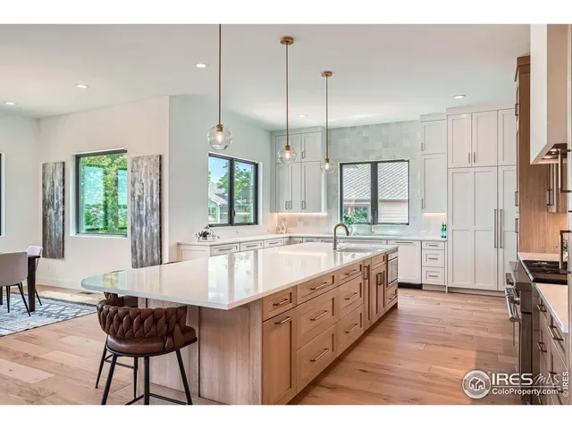 a large kitchen with kitchen island a large island in the center