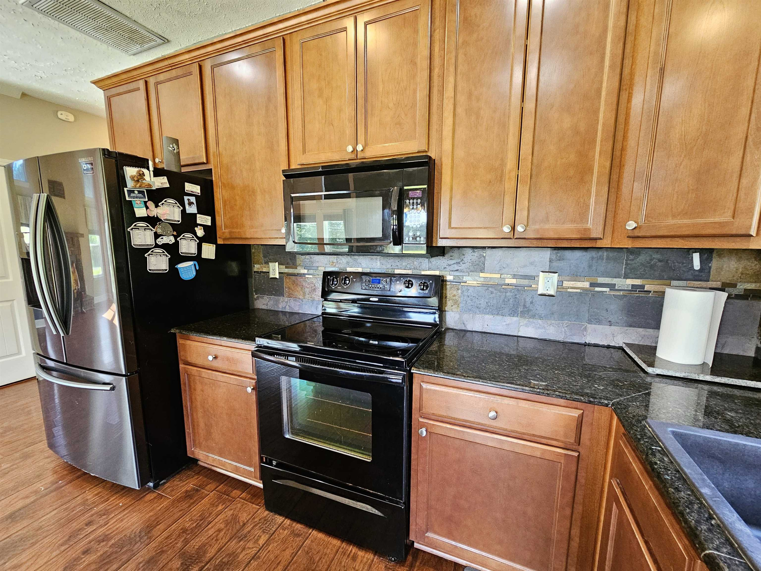 270 Hughes Road East Jackson, TN 38305 - Photo 16 of 48 a kitchen with stainless steel appliances granite countertop a refrigerator stove and sink