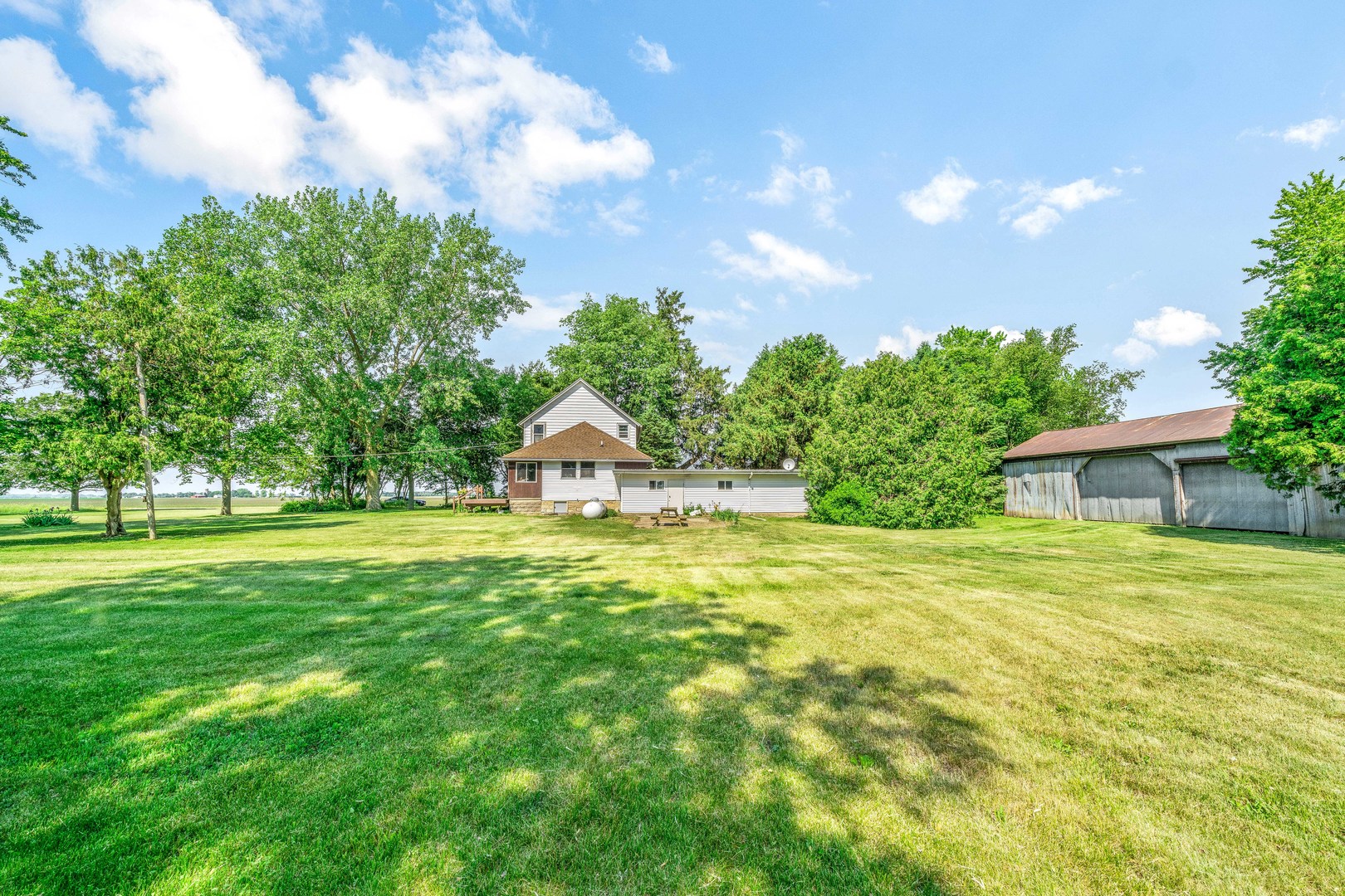 3700 Kane Road Leland, IL 60531 - Photo 22 of 30 a view of a house with a big yard and large trees