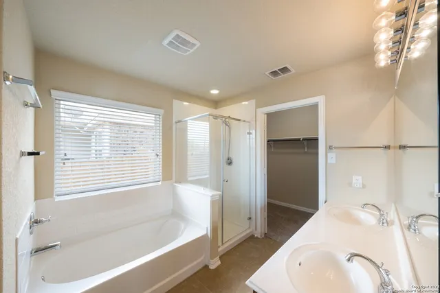 a bathroom with a tub sink and shower