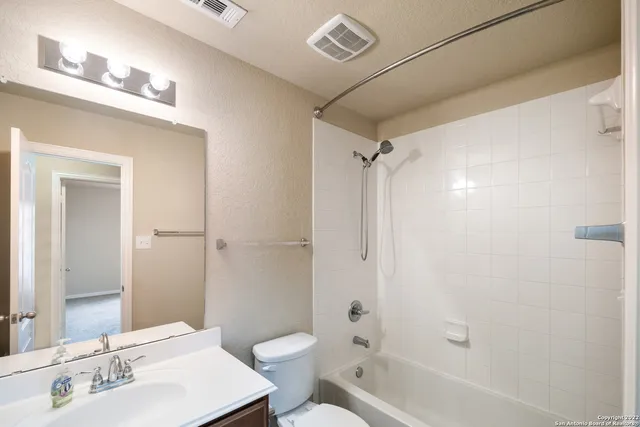 a bathroom with a sink mirror toilet and bathtub