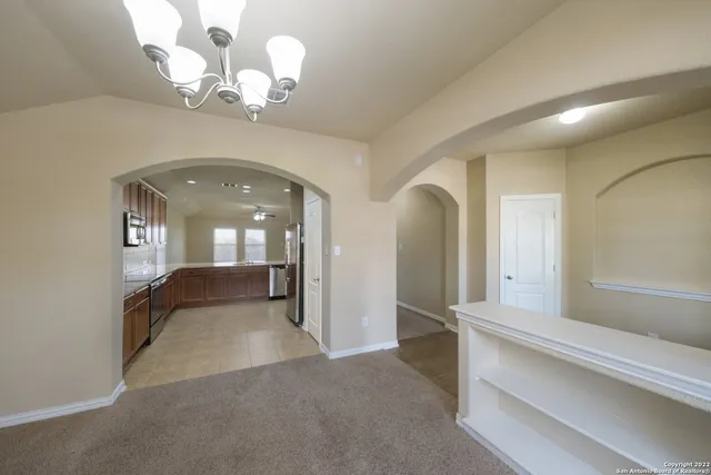 a view of a hallway with chandelier