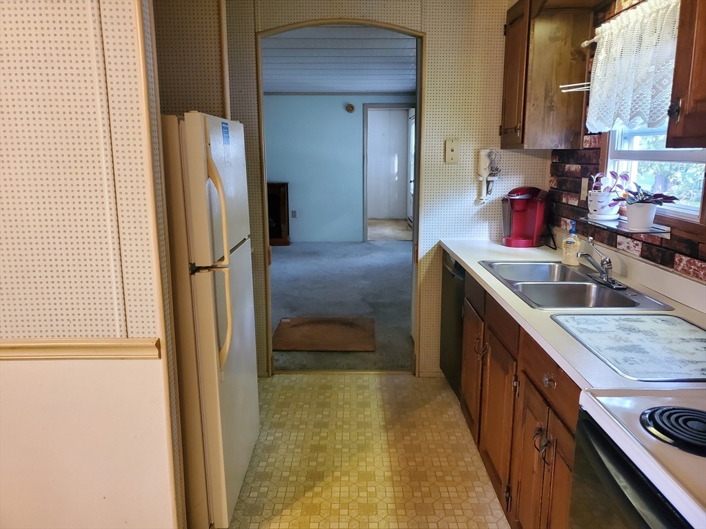 10 5th Street Brookfield, MA 01506 - Photo 4 of 17 a kitchen with stainless steel appliances granite countertop a refrigerator and a sink
