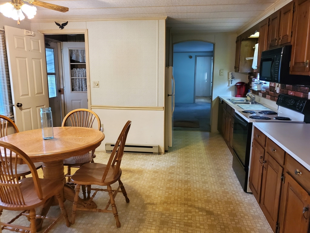 10 5th Street Brookfield, MA 01506 - Photo 6 of 17 a kitchen with stainless steel appliances granite countertop a sink a stove a refrigerator a table and chairs