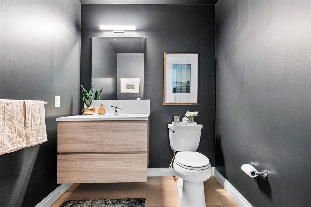 133 Seaport Boulevard, Unit 920 Boston, MA 02210 - Photo 11 of 28 a bathroom with a sink toilet and mirror