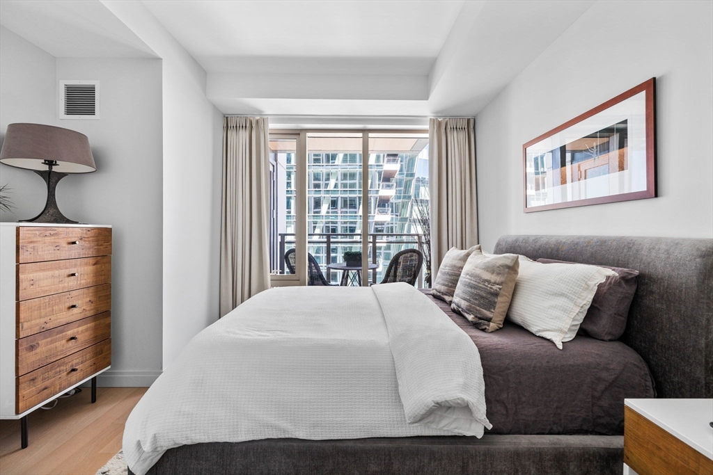 133 Seaport Boulevard, Unit 920 Boston, MA 02210 - Photo 15 of 28 a bedroom with a bed and a window