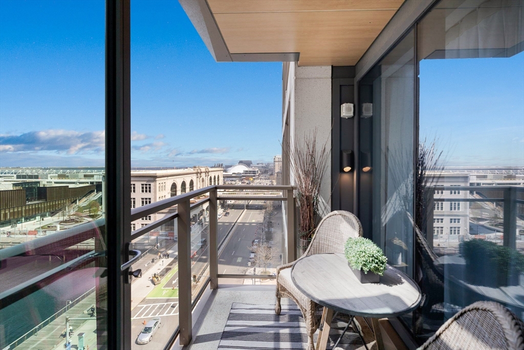 133 Seaport Boulevard, Unit 920 Boston, MA 02210 - Photo 18 of 28 a balcony with table and chairs