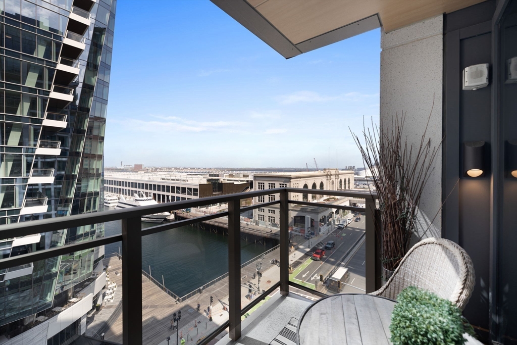 133 Seaport Boulevard, Unit 920 Boston, MA 02210 - Photo 19 of 28 a view of a balcony with chair and iron fence