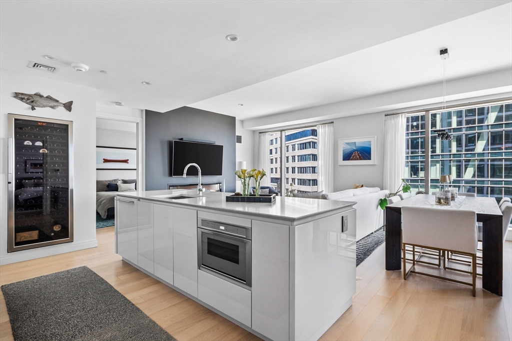 133 Seaport Boulevard, Unit 920 Boston, MA 02210 - Photo 2 of 28 a kitchen with a sink stove and cabinets