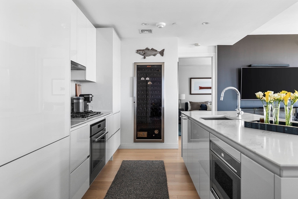 133 Seaport Boulevard, Unit 920 Boston, MA 02210 - Photo 3 of 28 a kitchen with a sink stove and refrigerator