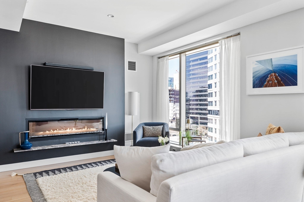 133 Seaport Boulevard, Unit 920 Boston, MA 02210 - Photo 4 of 28 a living room with furniture and a flat screen tv