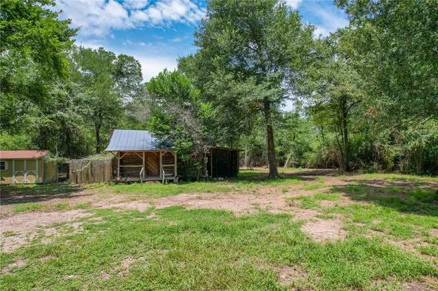 a backyard of a house with yard and trampoline