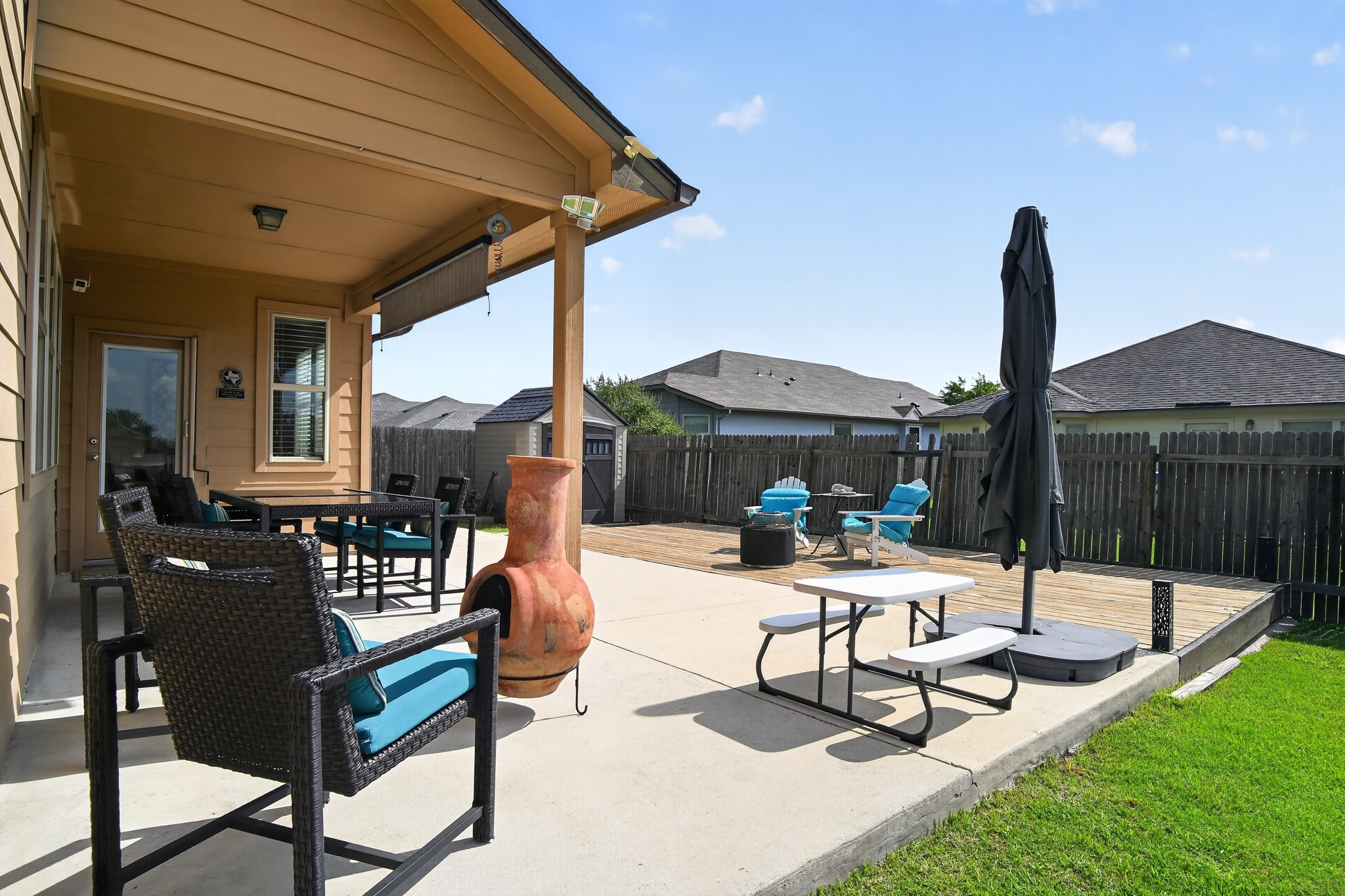 16816 Ruggio Road Pflugerville, TX 78660 - Photo 25 of 30 A spacious backyard features a covered patio, an open-air deck, and ample green space for outdoor leisure.