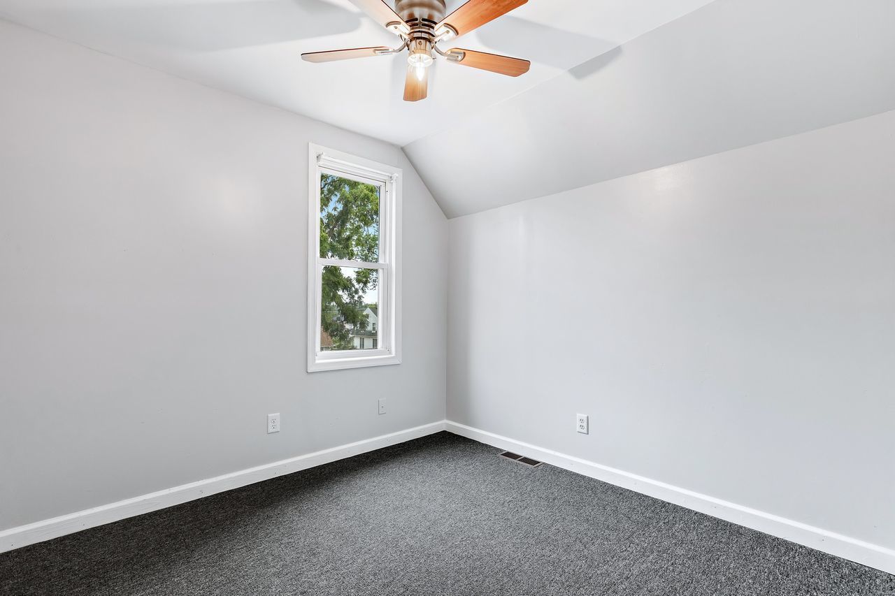 319 Wabash Street Elgin, IL 60123 - Photo 15 of 18 an empty room with a window and a fan