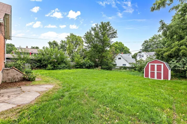 a view of a tree in front of a yellow house