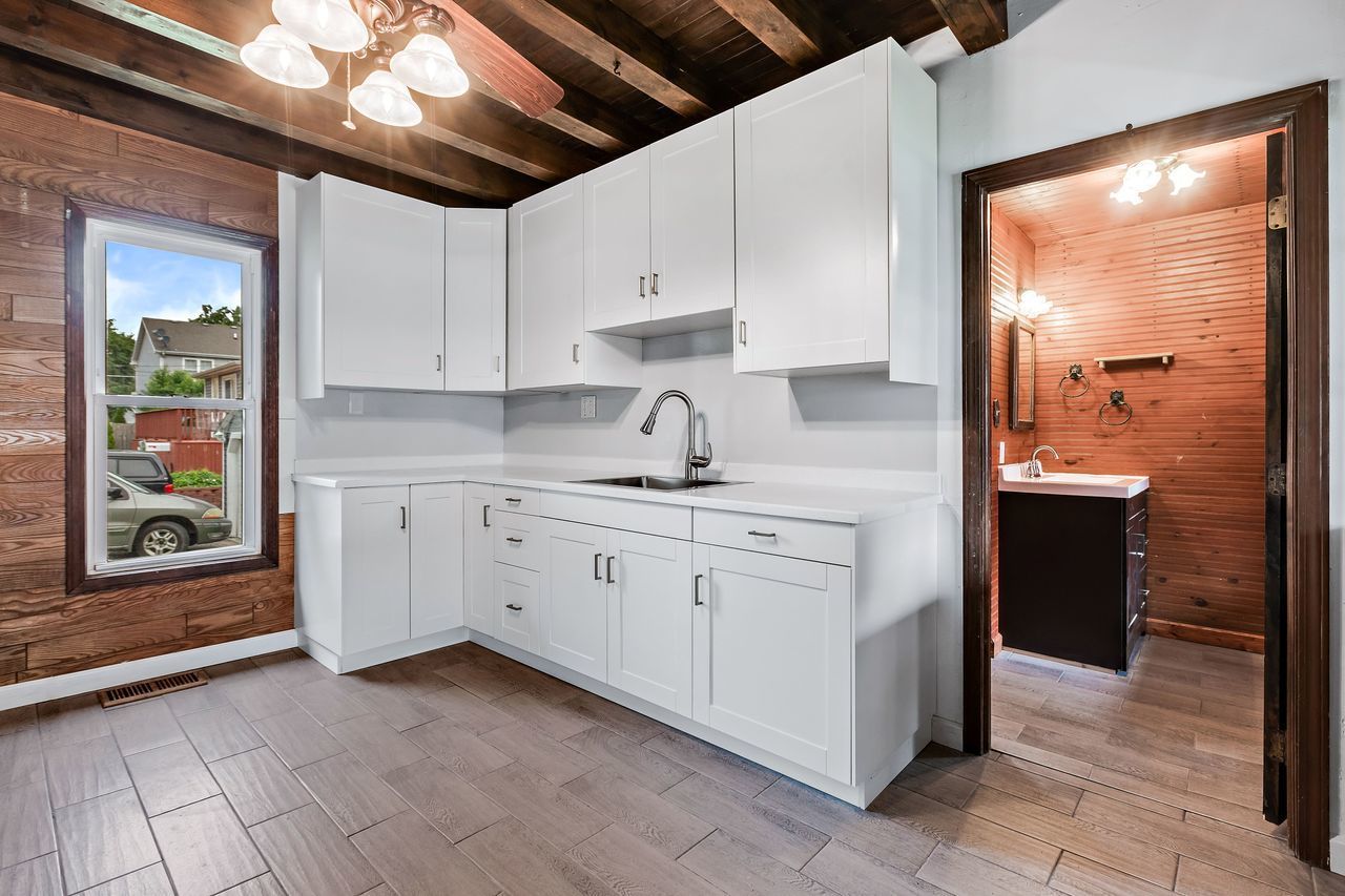 319 Wabash Street Elgin, IL 60123 - Photo 5 of 18 a kitchen with cabinets a sink and appliances
