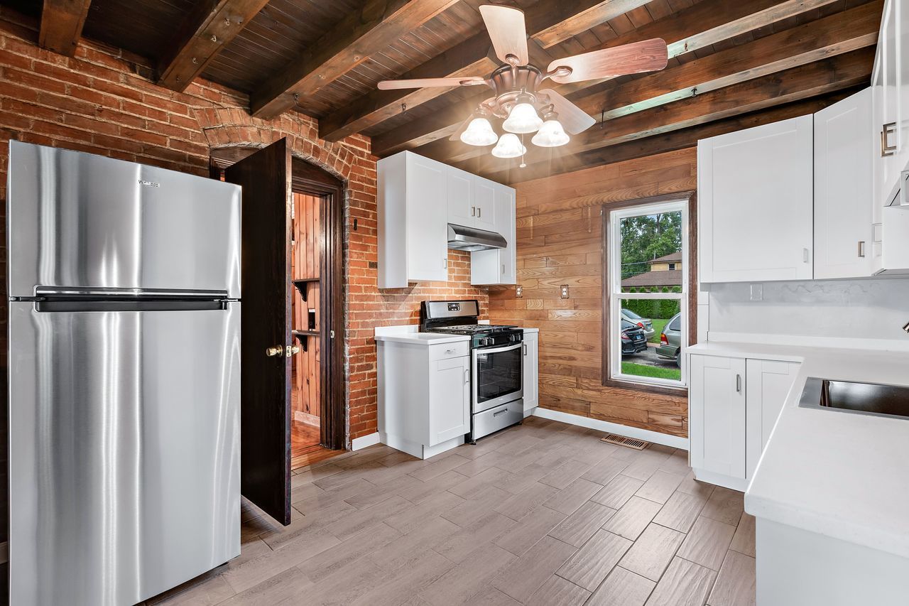 319 Wabash Street Elgin, IL 60123 - Photo 6 of 18 a kitchen with stainless steel appliances granite countertop a refrigerator and a stove top oven