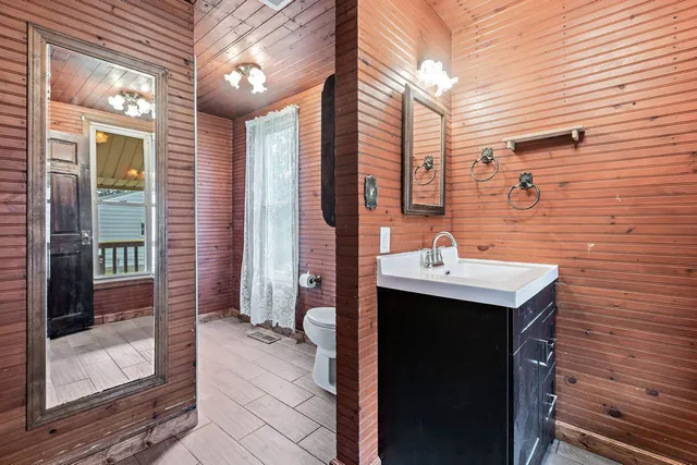 a bathroom with a sink a mirror and shower