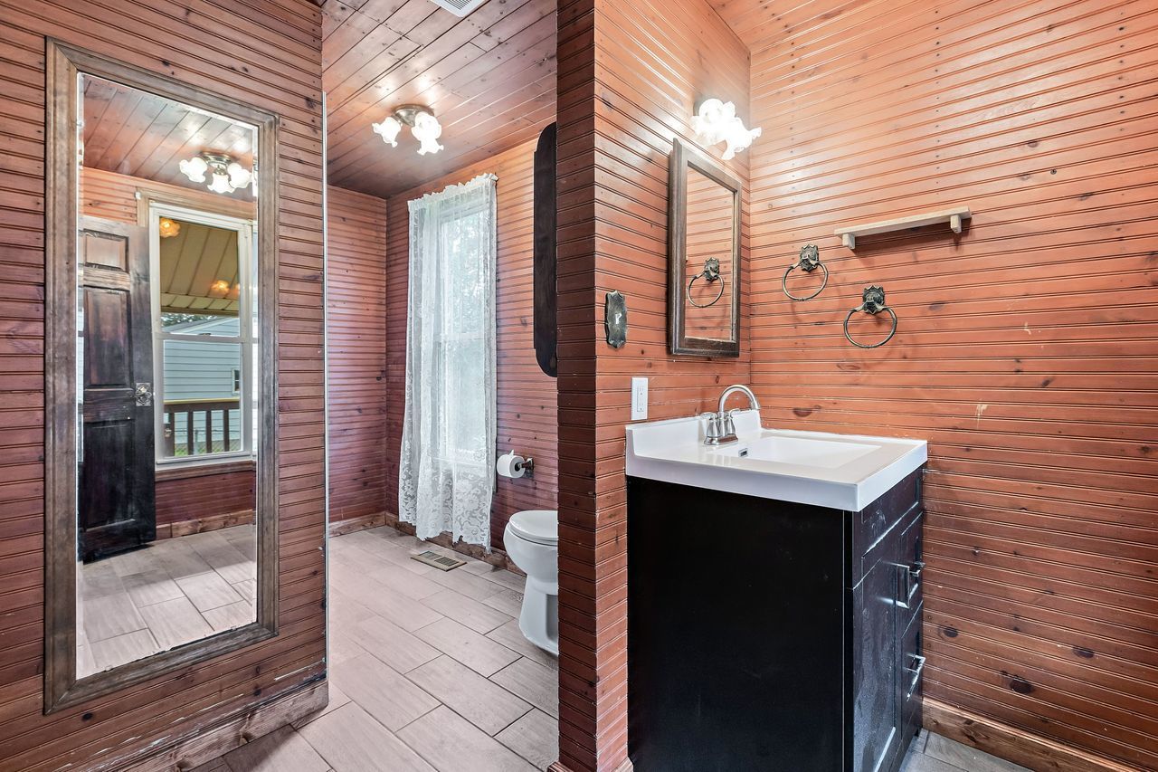 319 Wabash Street Elgin, IL 60123 - Photo 8 of 18 a bathroom with a sink a mirror and shower