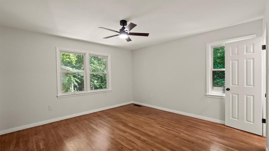 4600 Robinwood Drive Waco, TX 76708 - Photo 17 of 24 a view of empty room with wooden floor and fan