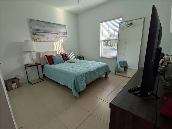 a bedroom with a bed dresser and a window