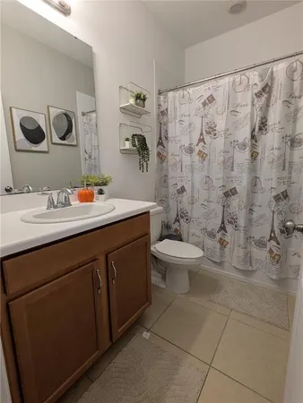 a bathroom with a double vanity sink toilet and a mirror