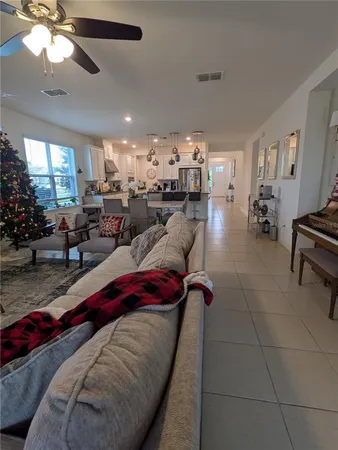 a living room with furniture and a chandelier