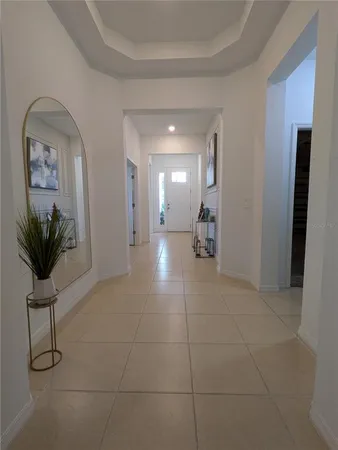 a view of a hallway to a livingroom with furniture