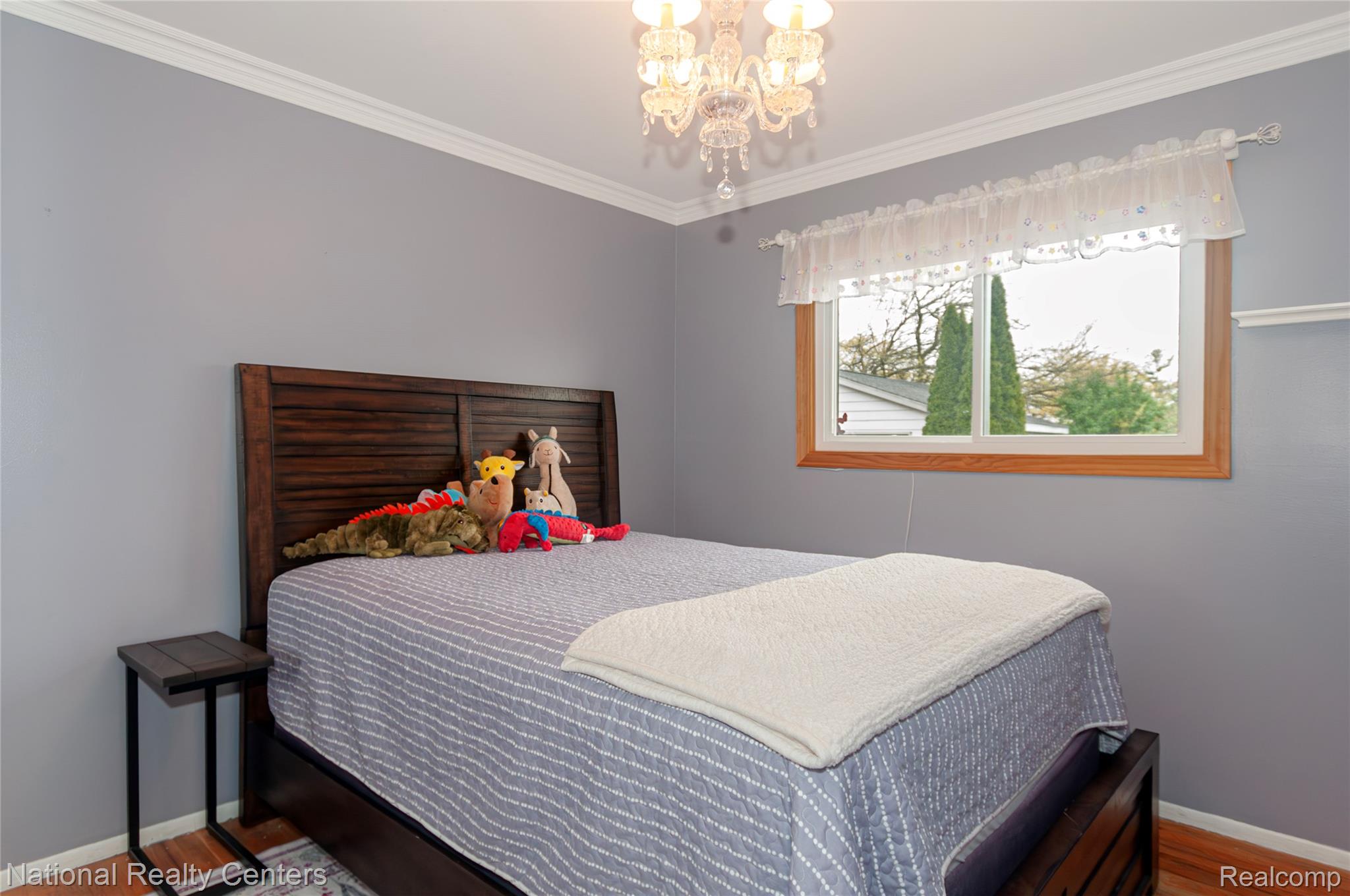 2446 Milverton Road Troy, MI 48083 - Photo 20 of 41 Bedroom with light wood-type flooring, crown molding, and a chandelier