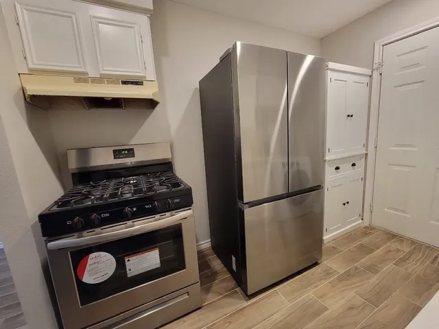 a kitchen with a stove and a refrigerator