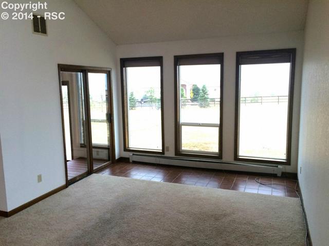 9815 Raygor Road Colorado Springs, CO 80908 - Photo 9 of 17 Family room off of Dining room...entry to enclosed patio and exit to back yard