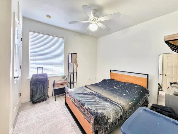 a bedroom with a bed and a chandelier