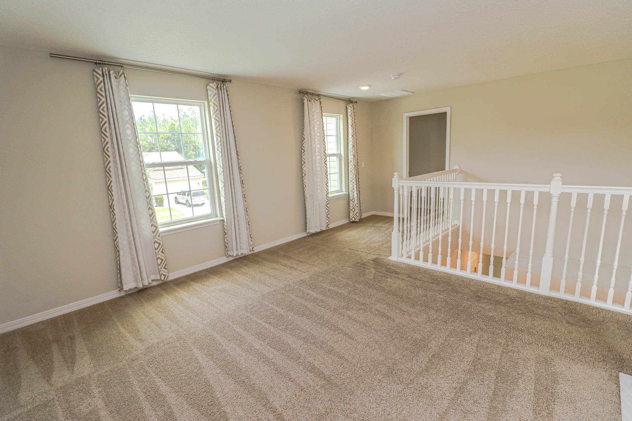 554 Tumbled Stone Way St. Augustine, FL 32086 - Photo 18 of 44 a view of an empty room with a window