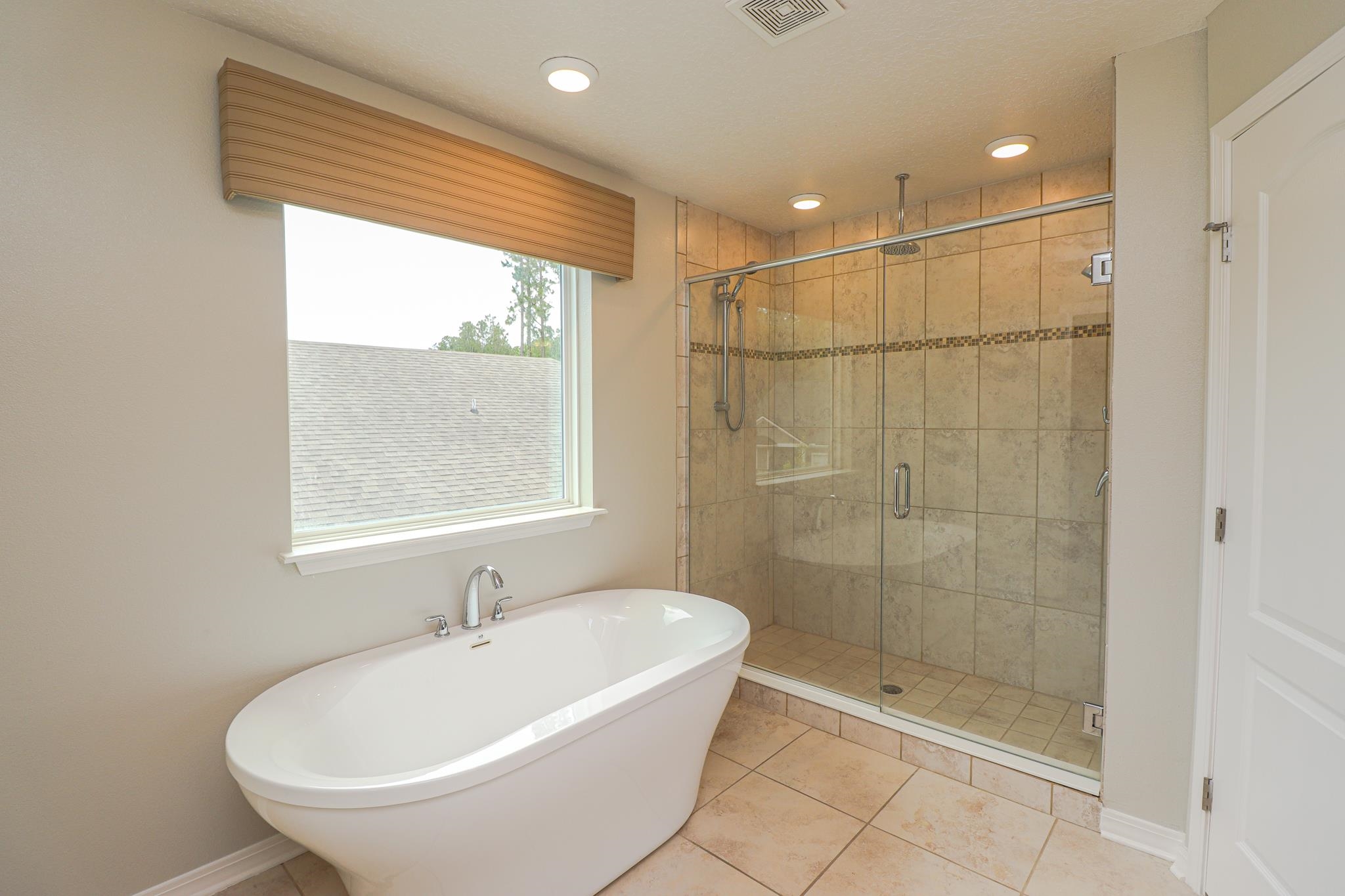 554 Tumbled Stone Way St. Augustine, FL 32086 - Photo 24 of 44 a bathroom with a bathtub and a shower