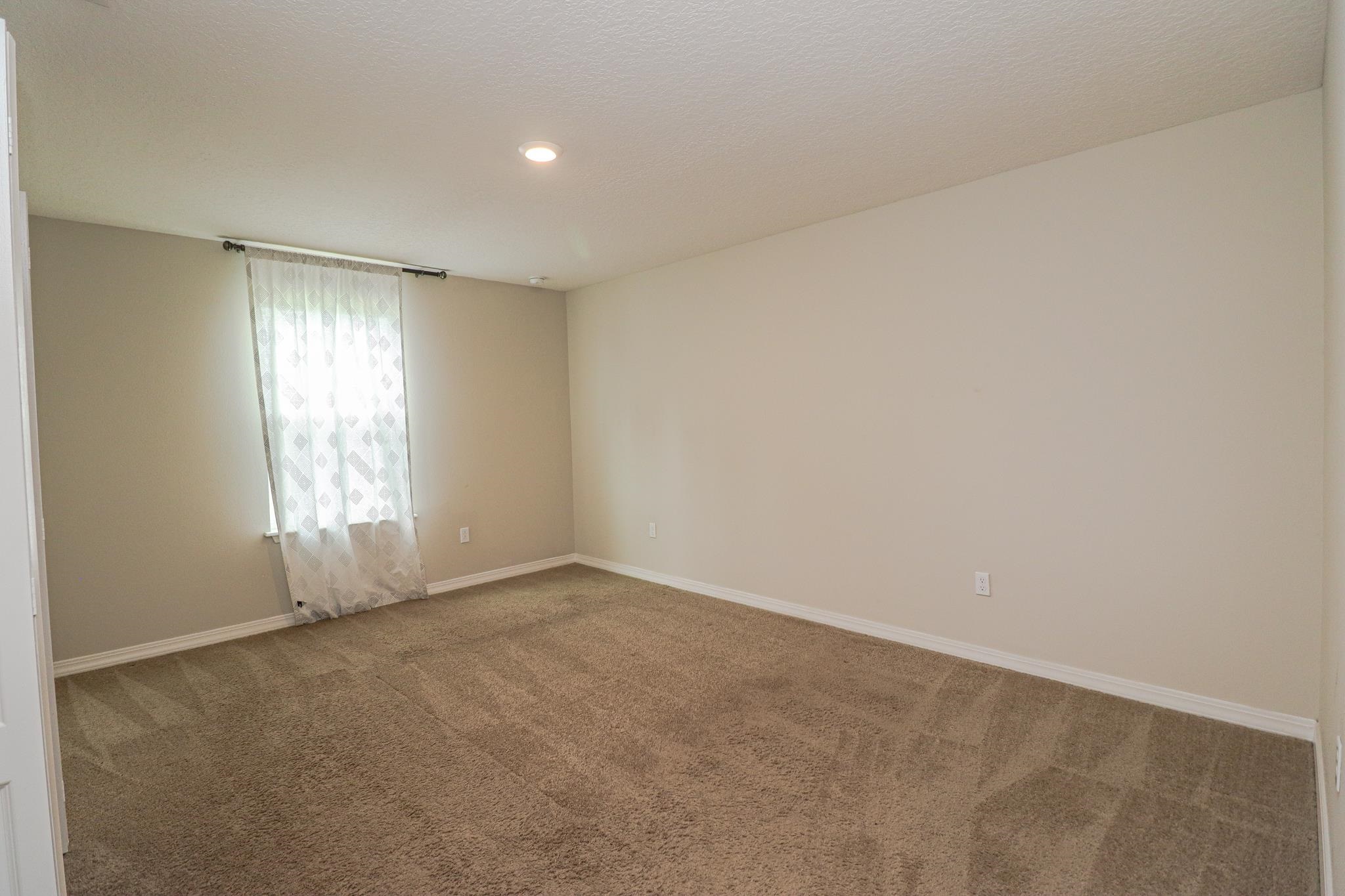 554 Tumbled Stone Way St. Augustine, FL 32086 - Photo 28 of 44 an empty room with windows