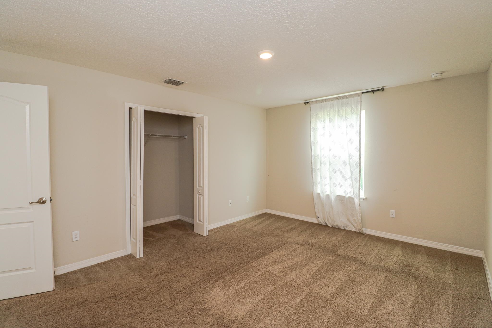 554 Tumbled Stone Way St. Augustine, FL 32086 - Photo 29 of 44 a view of an empty room with a window